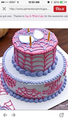 two tiered cake decorated with pink and purple icing