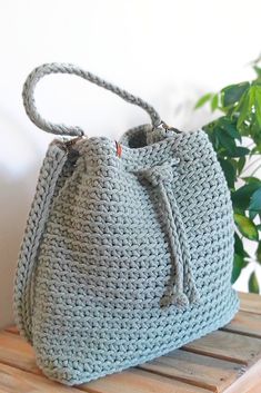 This drawstring bucket bag is stylish yet classic accessory not only for summer! Can be worn as a handbag, as a shoulder bag or as a crossbody bag. Many colors and lining patterns to choose from. #sackbag #satchelbag #bucketbag #drawstringbag #handbag #crossbodypurse #crochetpurse Casual Crochet Pouch Bag With Braided Handles, Handmade Casual Bucket Bag For Daily Use, Casual Handmade Bucket Bag In Pouch Shape, Casual Handmade Pouch Bucket Bag, Casual Handmade Bucket Bag For Everyday Use, Everyday Crochet Bucket Bag With Braided Handles, Casual Crochet Bucket Shoulder Bag, Casual Crochet Bucket Bag With Braided Handles, Handmade Cotton Hobo Bag For Travel