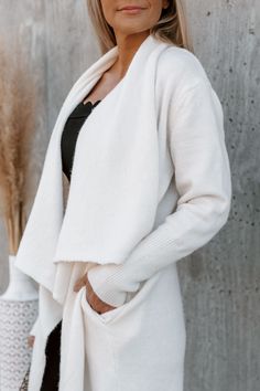 Our "Everyday Style" oversized cardigan jacket is so cozy and cool! This classic cream pocketed cardigan features an open front and long sleeves. Throw this piece on with the "Lamar" tank bodysuit and the "Liam" denim black jeggings! Oversized Jacket Model is 5"7 in a size small Fall Outerwear Pieces Cream Knit Cardigan Open Front Pockets Colors May Vary Patterns May Vary Cozy Fit Outerwear With Soft Texture For Layering, Cozy Fit Soft Texture Outerwear For Layering, Fall Outerwear With Soft Texture For Everyday, Winter White Long Sleeve Cardigan With Pockets, Soft Texture Outerwear For Everyday Fall Use, Soft Texture Outerwear For Fall, White Sweater Coat With Pockets For Fall, Cream Sweater Coat For Winter, White Fall Sweater Coat With Pockets