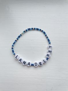 Lana Del Rey beaded bracelet. Made to fit each customers wrist. Can personalise colour of beads Lana Del Rey Clay Bead Bracelet, Personalized Blue Charm Bracelet With Round Beads, Casual Customized Blue Beaded Bracelets, Adjustable Blue Name Bracelet With Colorful Beads, Blue Name Bracelet With Colorful Beads As Gift, Blue Charm Bracelet With Letter Beads, Blue Charm Bracelet With Letter And Round Beads, Custom Name Beaded Bracelets For Personalized Gift, Customizable Bracelets With Round Beads For Personalized Gift