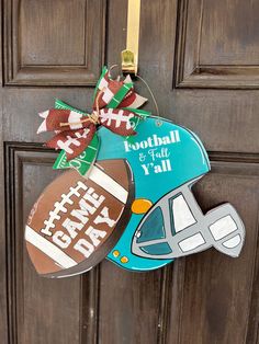 a football ornament hangs on the front door of a home decorated for father's day