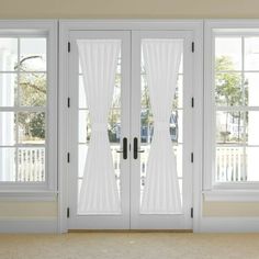 two white french doors with sheer curtains on them