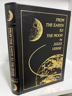 a black and gold book with the title from the earth to the moon written on it