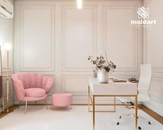 a pink chair sits in front of a white desk with a gold frame and mirror