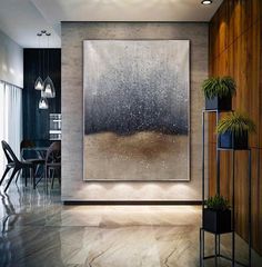 an abstract painting hangs in the middle of a room