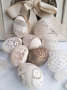 an arrangement of white and silver decorated eggs