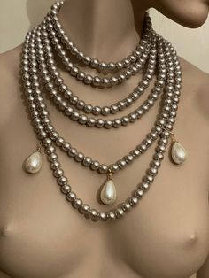 Multi strand pearl necklace. Six strands of grey beige pearls with three huge milk white tear drop pearls. I have used 10 mm white glass pearls. Has extender chain at the back , stainless steel so it does not tarnish. Cameo Choker Necklace, Baroque Necklace, Baroque Jewelry, Multi Strand Pearl Necklace, Layered Pearl Necklace, Bridal Pearl Necklace, Pearl Drop Necklace, Vintage Style Earrings, Necklace Bridal