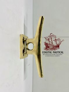 a close up of a door handle with a ship on it