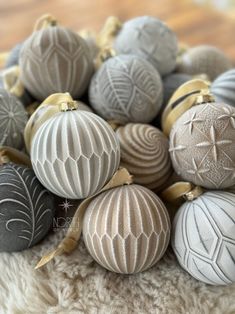 a pile of christmas ornaments sitting on top of a white blanket