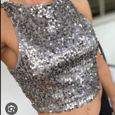 Express Sequin Halter Crop Top! It Is Super Trendy And Can Be Worn With Leggings, Jeans, Pants, Or Shorts Making It Very Versatile. The Inside Is A Soft Material And Is 100% Polyester Making It A Comfy Yet Stylish Addition To Your Wardrobe. Perfect For Upcoming Christmas Parties & New Years Silver Sleeveless Crop Top For Evening, Silver Crop Top For Summer Party, Silver Sequined Sleeveless Crop Top, Silver Sleeveless Crop Top For Night Out, Fitted Silver Sleeveless Crop Top, Elegant Silver Crop Top For Party, Silver Crop Top For Party Season, Silver Fitted Crop Top For Night Out, Silver Crop Top For Night Out In Spring