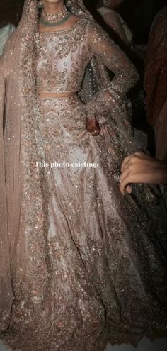 a woman in a wedding dress is posing for the camera