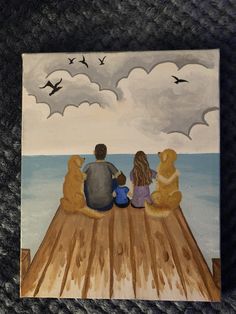 two people sitting on a dock with dogs and birds flying over the water behind them