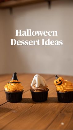 three cupcakes decorated with halloween decorations on a table