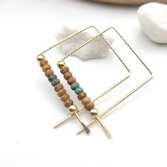 Experience the perfect blend of modern and bohemian style with these handmade Square Gold Hoops earrings. Crafted with 14k Gold-Filled wire and green and tan seed beads, they are a unique and captivating accessory that will make any outfit stand out. Make a statement and show off your unique style! Each side measures approximately .75" Choice of earring packaging with fun quotes! (Picture 3) Gold-filled pieces have the same appearance as high carat gold, and gold-filled items, even with daily we Handmade Gold Beaded Brass Earrings, Multicolor Brass Beaded Earrings For Gift, Gold Square Beaded Jewelry, Square Gold Beaded Jewelry, Bohemian Gold Rectangular Beaded Earrings, Handmade Square Brown Jewelry, Green Copper Bead Earrings, Handmade Brown Square Jewelry, Multicolor Beaded Brass Earrings