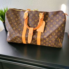 Louis Vuitton Monogram Keepall 45 Luggage Tote 100% Authentic Lv Brown And Tan Monogram Coated Canvas Louis Vuitton Keepall Bandoulire 45 With Brass Hardware Tan Vachetta Leather Trim Dual Rolled Top Handles Brown Canvas Lining And Two-Way Zip Closure At The Top Includes Luggage Tag And Strap Buckle Handle Drop 4" Height 10" Width 17.5" Depth 8" Excellent Condition No Visible Signs Of Wear Absolutely Flawless Bag. **** This Bag Cannot Be Bundled With Other Items For A Discount *** Please Look At Designer Brown Travel Bag With Large Capacity, Designer Brown Rectangular Luggage, Luxury Monogram Canvas Luggage, Luxury Monogram Canvas Rectangular Luggage, Elegant Monogram Canvas Luggage For Travel, Elegant Monogram Canvas Luggage With Sleeve, Designer Monogram Canvas Luggage For Everyday Use, Travel Bag With Luggage Sleeve In Monogram Canvas, Monogram Canvas Travel Bag With Luggage Sleeve