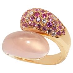 One-of-a-kind Design in Pink Gold with Rose Quartz, Diamonds, and Pink Sapphires The ring crafted in 18 karat pink gold features a unique design known as ‘wokkel’ in Dutch. The rose quartz gemstone is sculpted into a rounded shape that complements the mix of diamonds and various hues of pink sapphire, creating a soft and elegant piece that wraps beautifully around the fingers. The blue version of this ring, made in 18 karat white gold and adorned with blue topaz, sapphires, and diamonds, has alr Luxury Pink Cabochon Ring, Luxury Pink Gold Ring With Pink Sapphire, Luxury Pink Rings With Pave Setting, Pink Multi-stone Diamond Ring, Exquisite 14k Gold Pink Rings, Luxury Multi-stone Rose Gold Ring, Luxury Rose Gold Cabochon Rings, 14k Gold Pink Rings With Polished Finish, Elegant Pink Multi-stone Rings