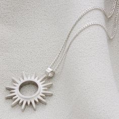 Exquisite sterling silver sun necklace from our stunning collection of Solar inspired jewellery. Featuring our striking contemporary sun motif this is a beautiful gift for her to celebrate a birthday, Christmas or milestone in life. Perfect worn on its own or layered up with our other personalised pieces. Beautifully feminine with a contemporary edge, the hollow sun pendant is finished with textured satin matt sun rays with a highly polished raised central section adding stunning contrast. Appro Celestial Sterling Silver Necklace With Sun Design, Silver Celestial Necklace With Sun Design, Sterling Silver Sun Design Spiritual Necklace, Sterling Silver Necklace With Sun Design, Minimalist Sterling Silver Jewelry With Sun Design, Silver Sun Necklace With Sun And Moon Design, Silver Necklace With Sun And Moon Design, Silver Sterling Silver Necklace With Sun Design, Silver Sun Design Necklace For Gift