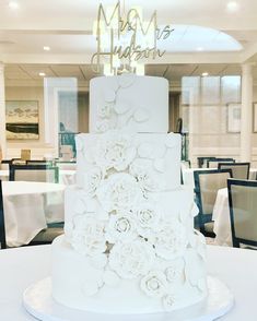 a white wedding cake sitting on top of a table