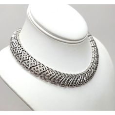 This is part of Chairish’s Costume Jewelry assortment.  1960s rhodium plated textured openwork articulated collar necklace with hook clasp. Marked "Monet" on a hangtag and "©" on the opposite side of the tag. Measures: 5 1/4 inches by 5 1/4 inches. Interior circumference on the largest setting is about 15 inches. Condition: Very good; it may have originally had a dangle at the end of the extension chain. Formal Round Metal Choker, Formal Metal Necklaces With Sterling Silver Clasp, Formal Metal Necklace With Oxidized Finish, Formal Necklaces With Sterling Silver Clasp, Formal Oxidized Metal Necklace, Formal Necklace With Sterling Silver Clasp, Retro Silver Metal Necklaces, Retro Silver Metal Necklace, Elegant Metal Choker With Oxidized Finish