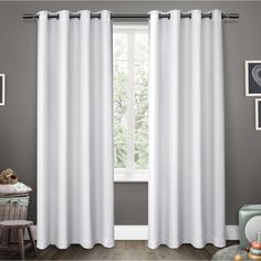 the white curtains are hanging in front of a window with grey walls and wooden floors