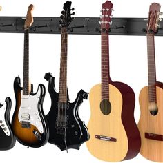 four guitars are hanging on a rack in the shape of guitar heads and neck shapes