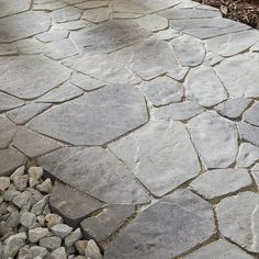 an outdoor walkway made out of stones and gravel