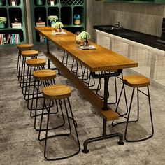 a long table with six stools in front of it