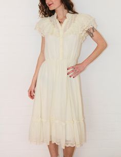 The most amazing vintage 1970s 'Candi Jones' ivory prairie frilled lace dress. So very sad this one doesn't fit me 😥 In excellent vintage condition.  Material: cotton/lace    Size: 6-8 Australian  Measurements  Length: 142cm Armpit to Armpit: 45cm Waist: 64-88cm Follow us on Instagram @cultofvtg Spring Cream Victorian Dress With Ruffles, Victorian Ruffle Dress For Spring, Spring Victorian Ruffle Dress, Cream Victorian Dress For Summer, Cottagecore Cream Vintage Dress With Ruffles, Cream Vintage Dress With Ruffles For Spring, Cream Victorian Dress In Cottagecore Style For Spring, Fitted Cream Victorian Dress For Summer, Spring Prairie Dress With Ruffles