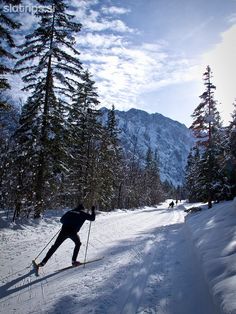 a man riding skis down a snow covered slope