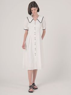 Editor's Notes Highlighted with the contrasting white on black outlines and buttons  this cotton dress has exaggerated collars that is balanced by a nipped-in waist.- Shirt-dress with two-button patterns down the front and on the sleeve-ends- Deep V-neckline with large collars that fall to the back as well- Puffed sleeves- Front and back nipped-in waist- Flared silhouetteMeasurements(in.)S / M- Length: 44.09 in. / 44.88 in. - Shoulder: 13.39 in. / 13.78 in. - Bust: 37.40 in. / 38. Elegant Daywear Dress With Striped Collar, Elegant Dresses With Striped Collar For Daywear, Classic Collared Daywear Dresses, Classic Workwear Dress With Striped Collar, White Collared Dress For Formal Occasions, Formal White Collared Dress, Collared White Midi Dress For Work, White Collared Midi Dress For Work, White Workwear Dresses With Covered Buttons