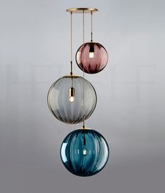 three colorful glass balls hanging from a ceiling