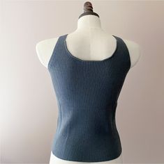 Elegant merino wool tank top. This soft and comfy tank top features a ribbed knit pattern that enhances the fabric's natural stretch and offers a figure-hugging fit. The v-neckline and wide shoulder straps provide a comfortable wear, while also giving it a contemporary edge. Professionally knitted. Features V-neckline, ideal for layering. Yarn Composition:100% Merino Wool Also available in 100% Cashmere option HERE. SIZING:Small/Medium: US size 4-8. Overall length: 21 inches. Measurements might Fitted Ribbed Tank Top For Layering, Fitted Ribbed Vest For Layering, Fitted Ribbed Merino Wool Top, Everyday Ribbed Sleeveless Sweater Vest, Ribbed Sleeveless Sweater Vest For Everyday, Ribbed Stretch Knit Tank Top, Stretch Ribbed Knit Tank Top, Ribbed Merino Wool Tops For Layering, Ribbed Knit Fitted Tank Top