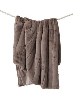 a brown towel hanging on a clothes line with some white string attached to the side