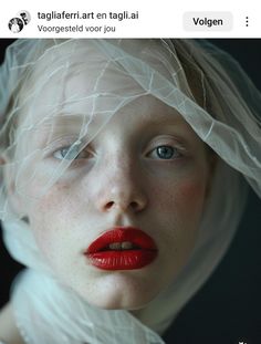 a woman with red lipstick and veil on her head