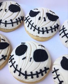 decorated cookies with black icing and white frosting are arranged in the shape of a skeleton