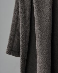 the back of a gray coat on a hanger