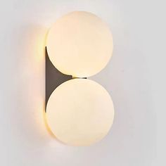 two round lights mounted on the side of a wall