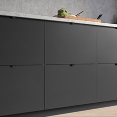 an image of a modern kitchen setting with grey cabinets and countertop space for cooking utensils