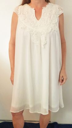 SMYS WHITE EMBROIDERED YOKE CHIFFON LAYER OVER POLYESTER LINING DRESS 2X NWOT  THIS DRESS IS BEAUTIFUL.   IT LOOKS AND FEELS GREAT NOTICE HOW FIGURE FLATTERING IT IS   UNDERARM TO UNDERARM: 24 INCHES WAIST: to 48 INCHES  LENGTH FROM BACK TO HEM: 36 INCHES  This is an anonymous auction. Only you will know you have bid.  Please feel free to ask any questions. I combine shipping. Fast shipping! I try to ship the same day I receive payment.  Please note that shipping is high due to the weight of the garment.   1970 SMYS    Exported By ExportYourStore :) Flowy White Dress With Lace Bodice, White Chiffon Mini Dress For Wedding, White Chiffon Mini Dress For Daywear, White Chiffon Dress With Lace Trim, White Sleeveless Mini Dress With Lace Top, Tampa Fl, Dress Clothes For Women, Feeling Great, Tampa