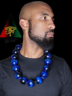 This handsome and eye catching piece is hand crafted and created by Eye Create LLC.  This item is stained in a beautiful custom made deep and vibrant royal blue. All stains are made by our company. All beads are solid and hand drilled by yours truly. These beads are highly glossed and stands out like no other!  The necklace can be purchased individually or as a set with the matching bracelet.   The bracelet is made from natural Blue Tiger eye, Black Obsidian, and Hematite gem beads.    Please fo Blue Lapis Lazuli Jewelry With Large Beads, Blue Wooden Beads Round Jewelry, Blue Wooden Round Beads Jewelry, Artisan Blue Jewelry With Large Beads, Blue Wooden Beaded Round Jewelry, Blue Necklaces With Wooden Beads, Lapis Lazuli Beaded Necklaces With Large Beads As Gift, Lapis Lazuli Beaded Necklace With Large Beads For Gift, Blue Spiritual Necklace With Wooden Beads