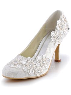 white wedding shoes with lace and flowers on the heels are ready to be used for brides