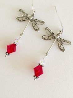 "Beautiful antique silver filigree dragonfly earrings featuring lovely large 8mm Siam red Swarovski Crystal and 4mm clear Swarovski Crystal AB. Silver dragonfly charms are 24 x 24mm and hang from Sterling silver ear wires. Total length is 2\". Lightweight and beautiful red crystal earrings! Available on Sterling silver ear wires or silver plated wires." Elegant Dragonfly Jewelry With Ear Wire, Elegant Dragonfly Earrings With Ear Wire, Elegant Dragonfly Jewelry For Jewelry Making, Elegant Hypoallergenic Dragonfly Earrings, Trendy Jewelry Ideas, Paris Charm Bracelet, Dragonfly Charm, Dragonfly Earrings, Button Jewelry