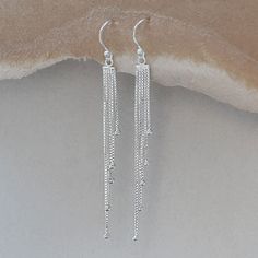 Our beautiful Sterling Silver Cascading Chain Drops Dangly Earrings are quite simply instant elegance. Prepare to stand out and dazzle with these gorgeous sterling silver earrings. With a luxurious polished finish and a wonderfully contemporary design these earrings could easily be described as breath taking. These earrings are a must for those special nights out and are sure to be treasured by anyone who owns them. All this and their price makes them incredibly affordable. All Martha Jackson jewellery comes complete with a gift box and blank gift card for you to write a short message on Made from Sterling Silver, keep shiny with an anti tarnish cloth Dimensions overall length 7.1cm Long Silver Earrings, Prom Earrings, Spiral Earrings, Earrings Bohemian, Handmade Charms, Dangly Earrings, Bar Earrings, Stunning Earrings, Silver Earrings Dangle