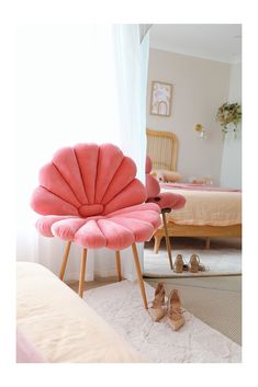 a pair of pink shoes sitting on top of a white rug next to a bed