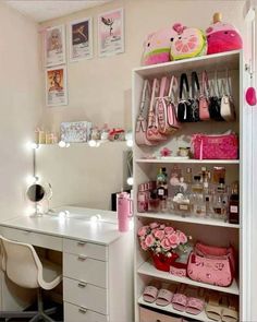 a white desk topped with lots of pink bags next to a shelf filled with purses