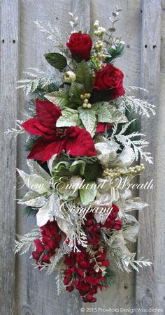 a bunch of flowers that are on top of a wooden fence with snow flakes