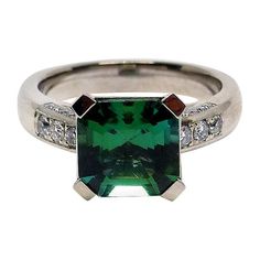 Thomas Leyser is renowned for his contemporary jewellery designs utilizing fine gemstones. This 18k white gold (8.30g) ring is set with 1x fine intense green-blue Tourmaline (facetted, 9x9mm, 3.20ct) + 26x Diamonds (brilliant-cut,G/VS, 0.32ct). Ringsize: 6 1/2 Ascher Cut, Green Diamonds, Modern Jewellery Design, Contemporary Engagement Rings, Green Tourmaline Ring, Contemporary Jewelry Design, Pink Tourmaline Ring, Modern Engagement Rings, White Diamond Ring