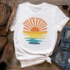 "This colorful retro t-shirt is perfect for summer days or any other day when it feels like summer! The beautiful design with the sunset rays and wavy water draws the eye. The groovy text \"Feels like summer\" above the design adds a playful touch that will bring a smile to everyone's face. The colors make it easy to match with almost every outfit.  Get ready for sunny days with this sunset t-shirt and feel the summer vibes! If you've been looking for a holiday t-shirt for yourself, your wife or best friend, you should get this \"Feel like summer\" tee today!  Bella + Canvas Brand Shirt ▶Unisex Adult Sizing ▶See Our Size Chart For Proper Sizing ▶Rolled sleeves are for styling purposes only ▶Props used in photos are not included with the purchase. ✈ PROCESSING & SHIPPING ✈ Processing Time: Retro T-shirt For Vacation, Trendy Multicolor T-shirt For Beach, Trendy Multicolor T-shirt For The Beach, Retro Multicolor T-shirt For Vacation, Trendy Multicolor T-shirt For Vacation, Cotton Retro Print Vacation Top, Cotton Retro Print Top For Vacation, Retro Printed Summer T-shirt, Vintage Summer Beach T-shirt