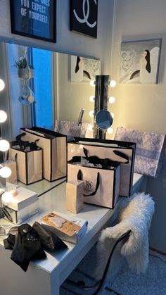 bags are sitting on a table in front of a mirror with lights around it and other items