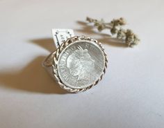 This coin signet ring is made of a British 5p coin which was decorated with braided silver wires and attached to a wide band, creating a lovely signet ring. The silver coin ring is designed in a vintage style and is available both in 14k gold plating and sterling silver The ring is a great cocktail ring and could also be a perfect pinky ring to be gifted for women Dimensions: The coin diameter is 1.8 cm ( a bit over 0.7 inches) The ring is quite wide at about 6mm (0.25 inches) The ring is availa Antique Engraved Coin Signet Ring, Antique Coin Shaped Engraved Signet Ring, Antique Coin-shape Engraved Signet Ring, Elegant Engraved Coin Rings, Vintage Coin Signet Ring As Gift, Vintage Coin Signet Ring For Gift, Vintage Engraved Coin Signet Ring, Vintage Coin Shaped Signet Ring Gift, Antique White Gold Signet Ring